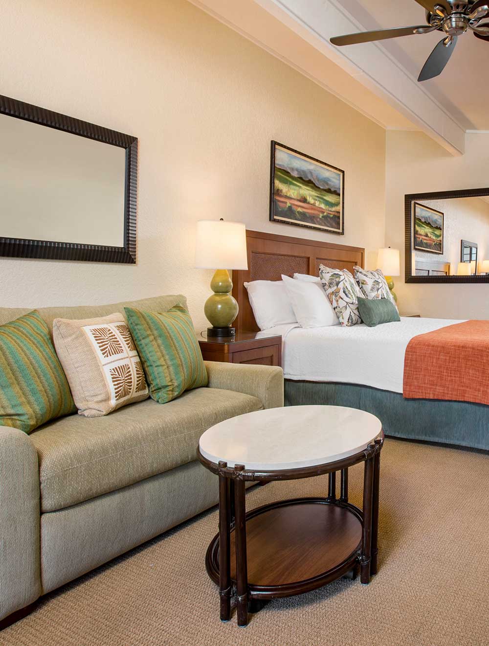 Living area with sofa and bed in an open layout facing the ocean