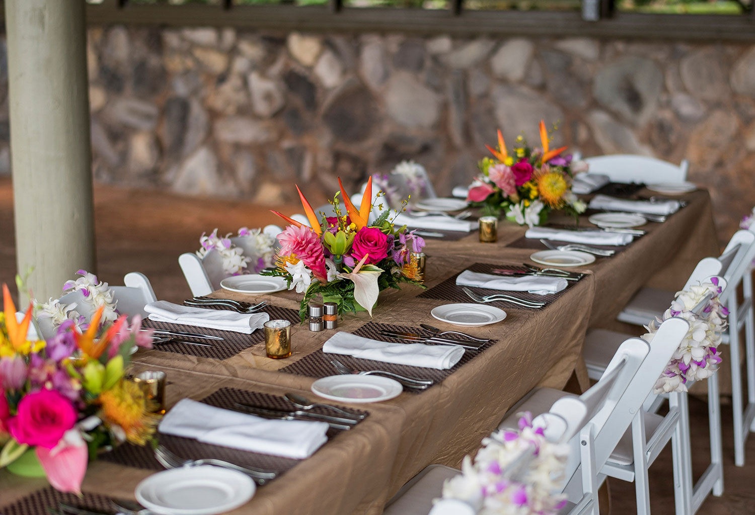 Elegant outdoor reception table setup with floral arrangements