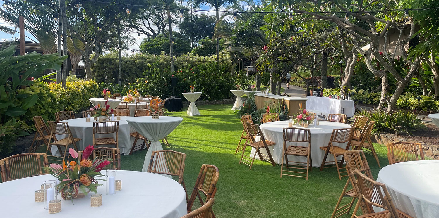 Garden reception with round tables and tropical setting
