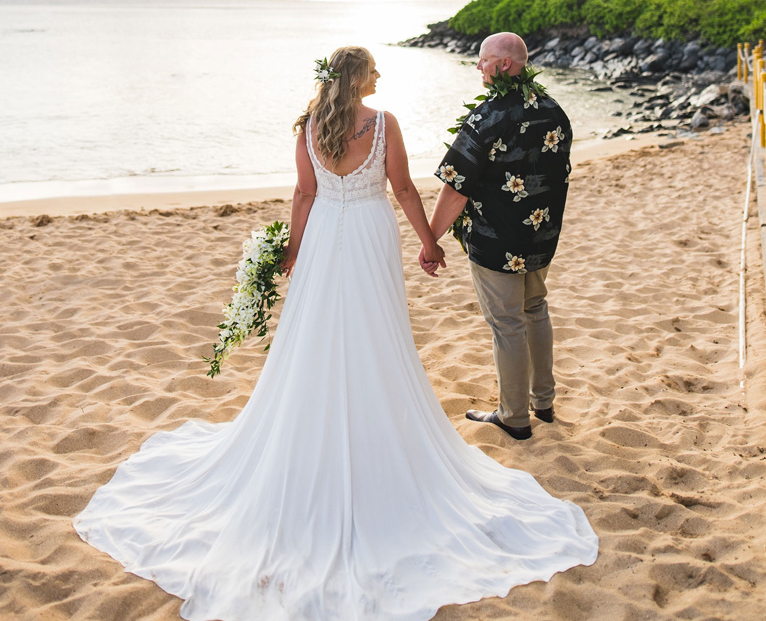 Oceanfront ceremony seating with palm trees and sunset views