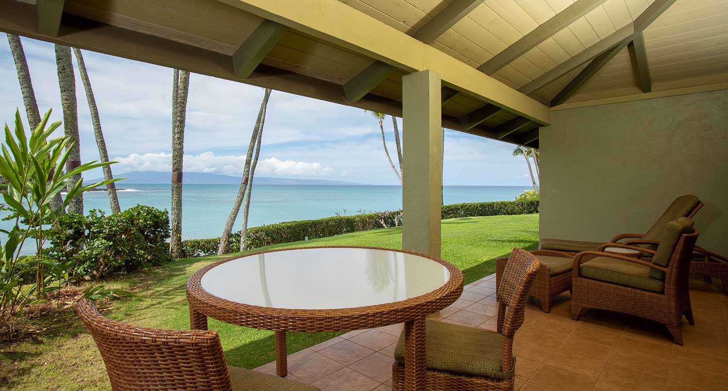 Oceanfront bedroom with sliding doors opening to private lanai and ocean view